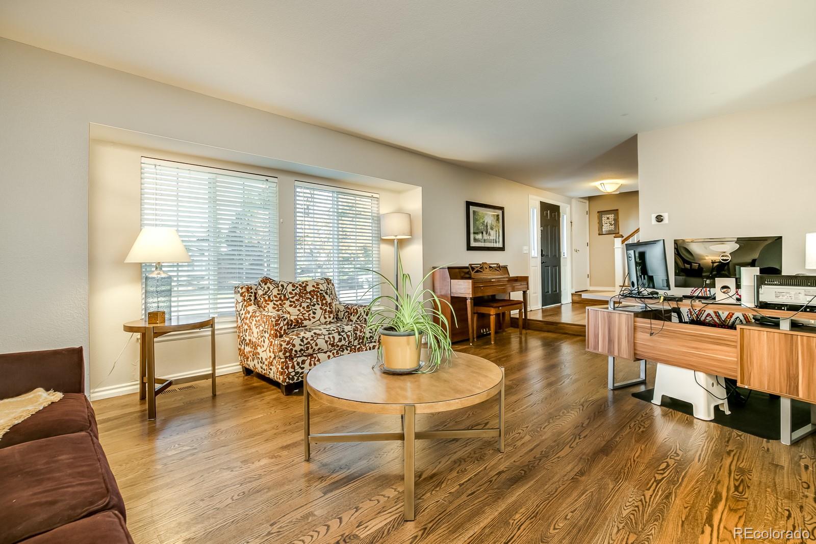 726 Northridge Road Highlands Ranch, CO 80126 - Photo 6 of 40 a living room with furniture and a table