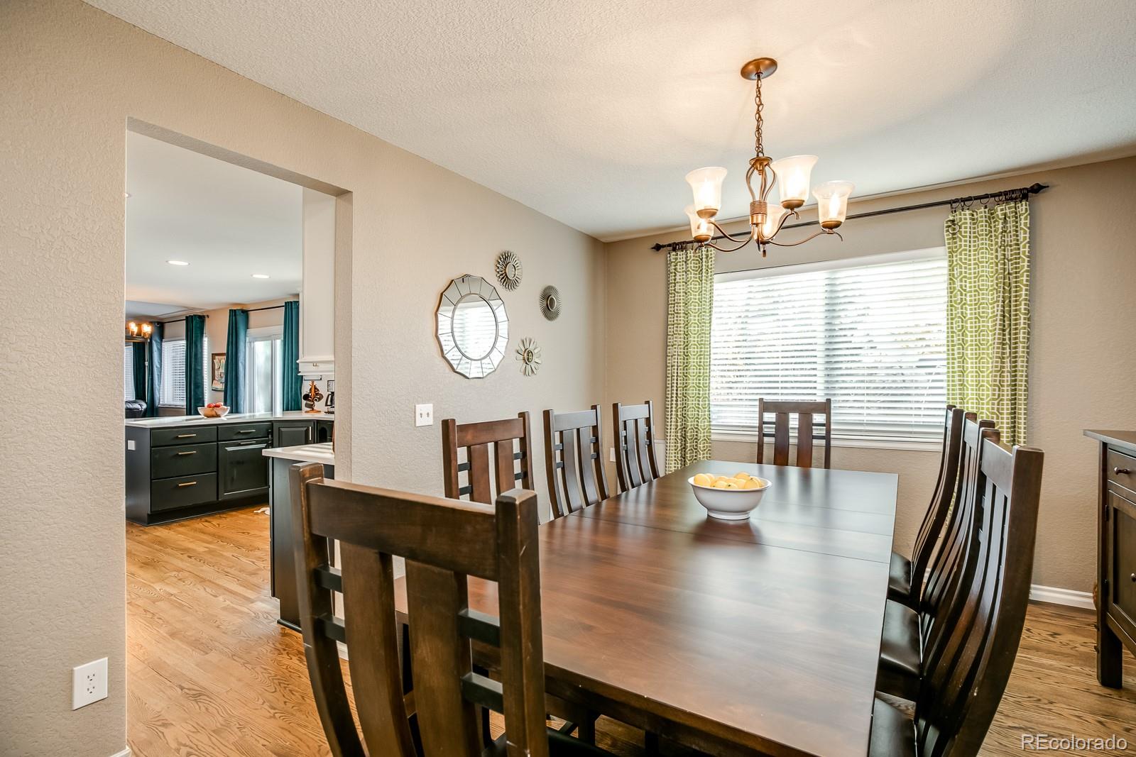 726 Northridge Road Highlands Ranch, CO 80126 - Photo 7 of 40 a view of a dining room and livingroom with furniture wooden floor a chandelier