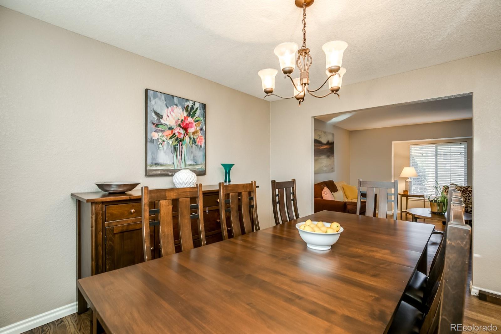 726 Northridge Road Highlands Ranch, CO 80126 - Photo 8 of 40 a view of a dining room with furniture wooden floor and chandelier