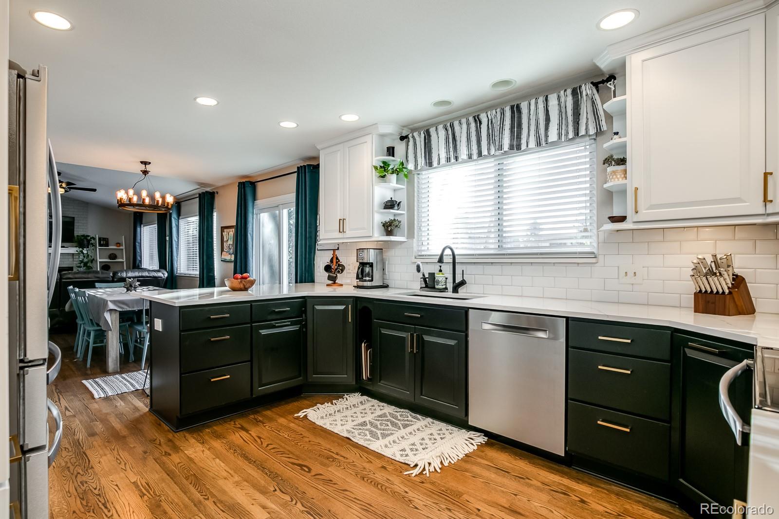 726 Northridge Road Highlands Ranch, CO 80126 - Photo 9 of 40 a kitchen with a sink stove and cabinets