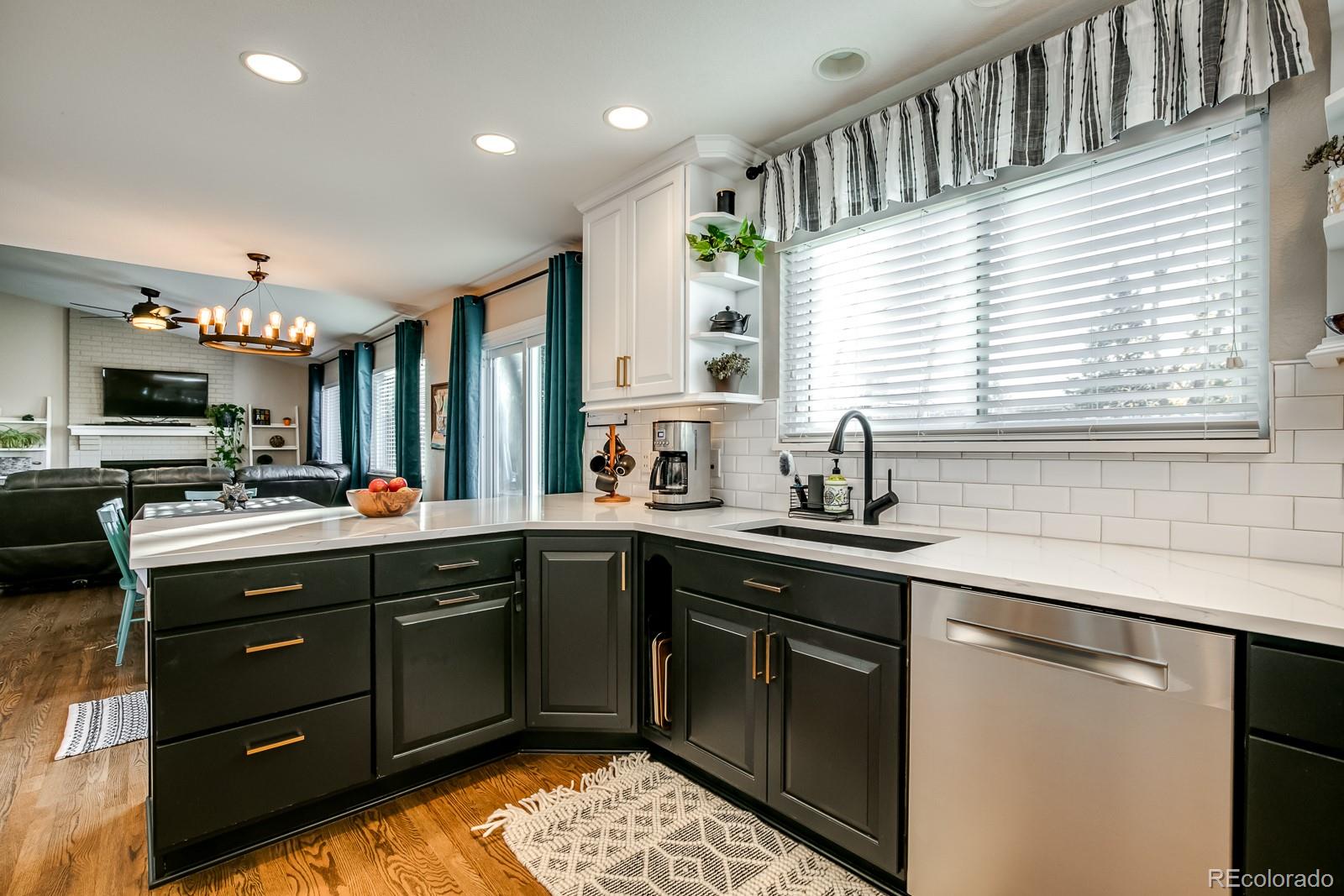 726 Northridge Road Highlands Ranch, CO 80126 - Photo 10 of 40 a kitchen with a sink stove and cabinets