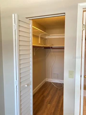a view of a room with wooden floor
