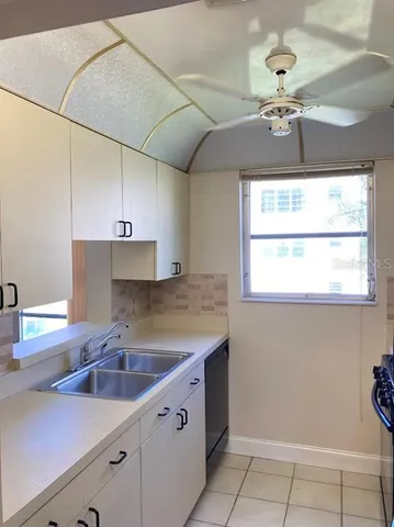 a kitchen with a sink cabinets and window