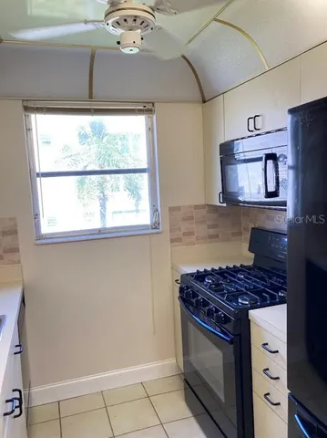 a kitchen with a stove and a microwave