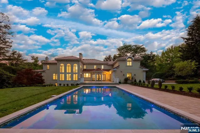 a front view of a house with swimming pool having outdoor seating