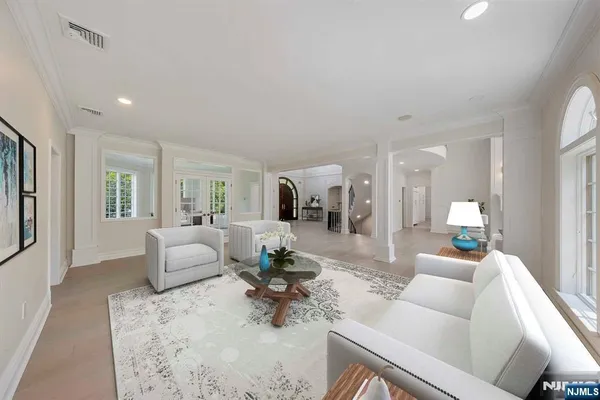 a view of a big room with windows and entryway