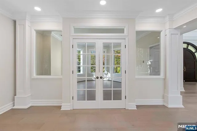 wooden floor fireplace and windows in an empty room