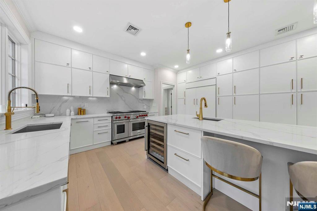 5 Ellen's Way Alpine, NJ 07620 - Photo 21 of 49 a kitchen with white cabinets and stainless steel appliances