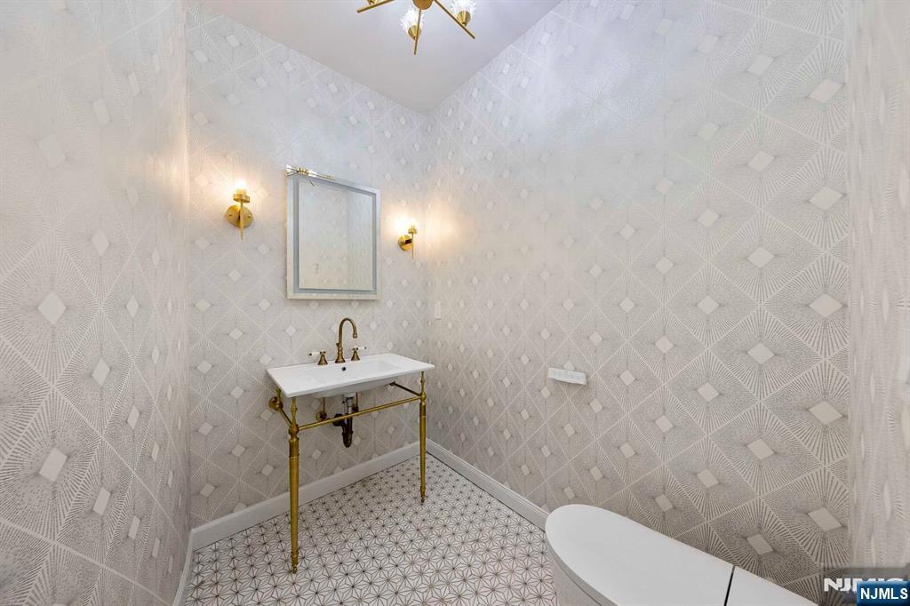 5 Ellen's Way Alpine, NJ 07620 - Photo 22 of 49 a bathroom with a sink a toilet and mirror