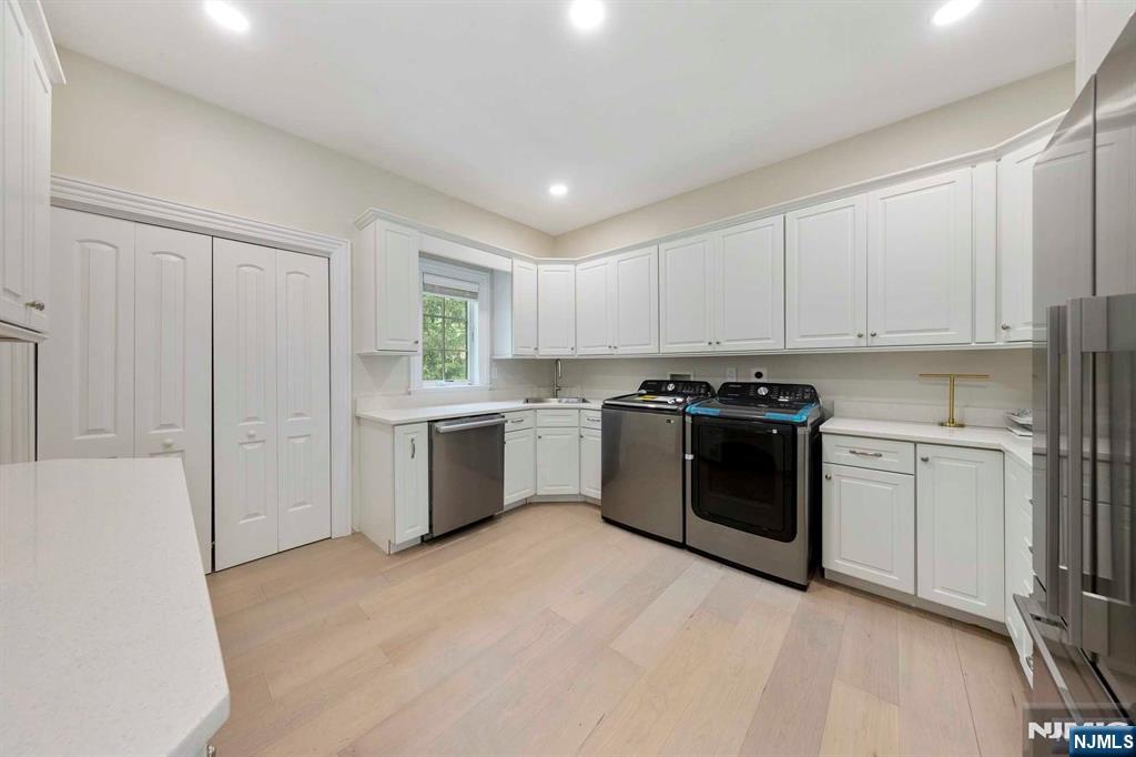 5 Ellen's Way Alpine, NJ 07620 - Photo 23 of 49 a kitchen with a white cabinets and white appliances