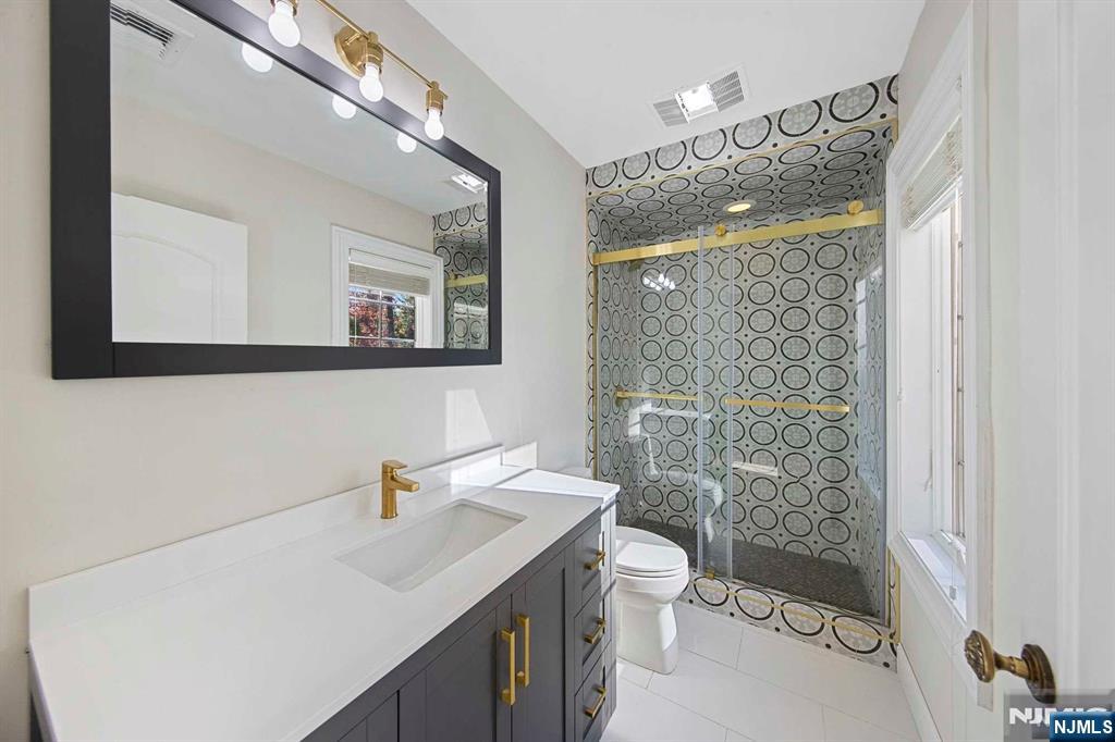 5 Ellen's Way Alpine, NJ 07620 - Photo 25 of 49 a bathroom with a sink a toilet a mirror a vanity and shower