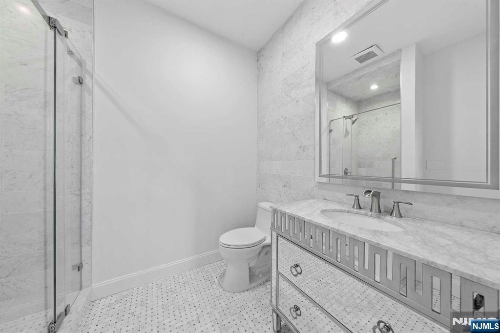 5 Ellen's Way Alpine, NJ 07620 - Photo 27 of 49 a bathroom with a granite countertop sink a toilet and a mirror