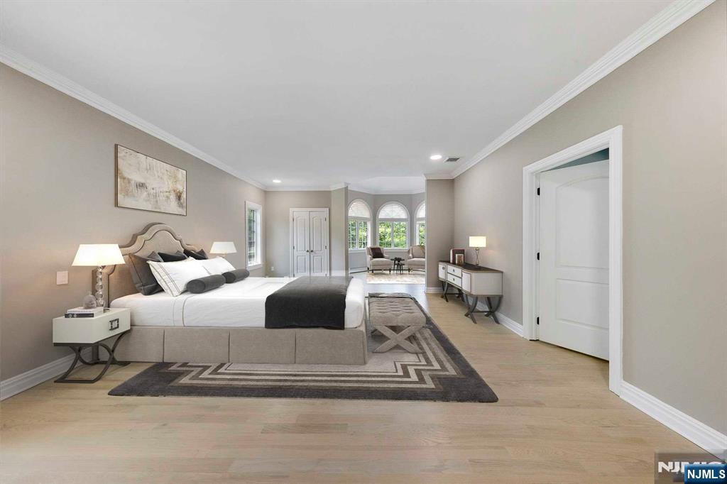 5 Ellen's Way Alpine, NJ 07620 - Photo 30 of 49 a spacious bedroom with a bed and a large mirror