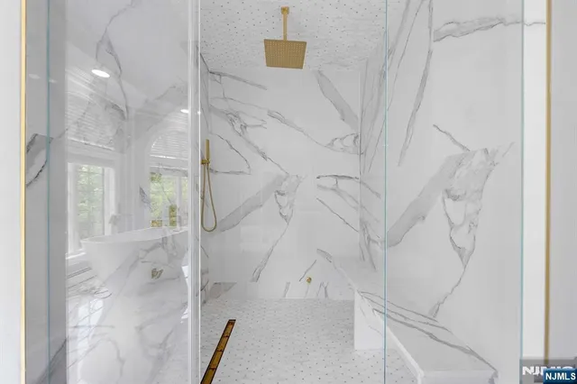 a bathroom with a double vanity sink toilet and shower