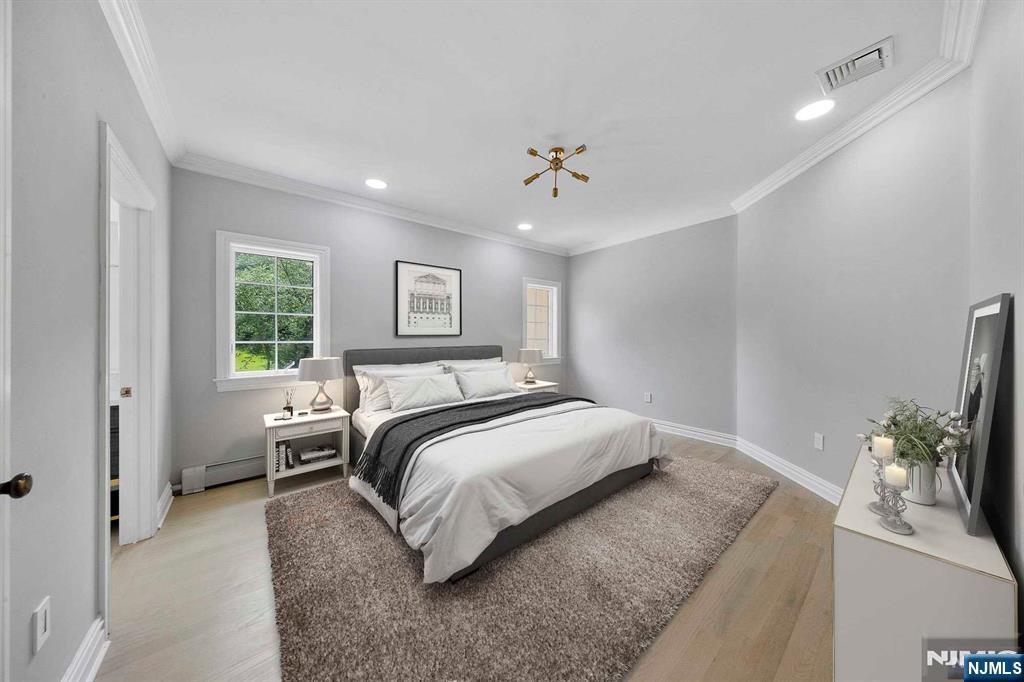 5 Ellen's Way Alpine, NJ 07620 - Photo 37 of 49 a bedroom with a large bed and a chandelier