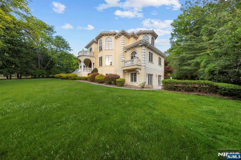 5 Ellen's Way Alpine, NJ 07620 - Photo 4 of 49 a view of a white house with a big yard and large trees