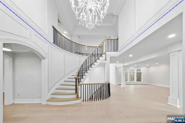 a living room with furniture a fireplace and a chandelier