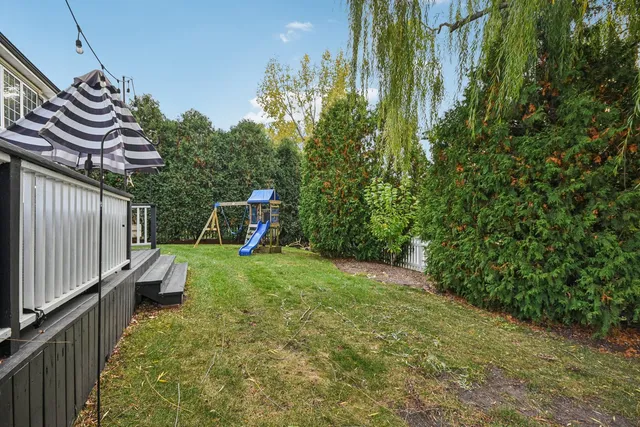 a aerial view of a house next to a yard