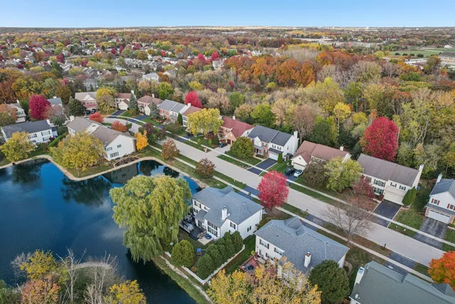 an aerial view of a house with a swimming pool patio and outdoor seating