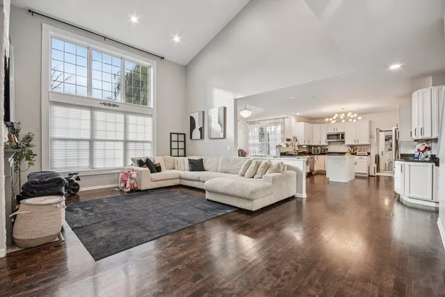 a living room with furniture and painting on the wall