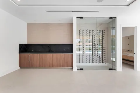 a view of an empty room with glass door and balcony