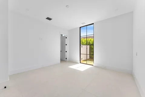an empty room with windows and closet