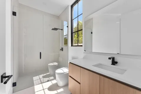 an empty room with wooden floor and mirror