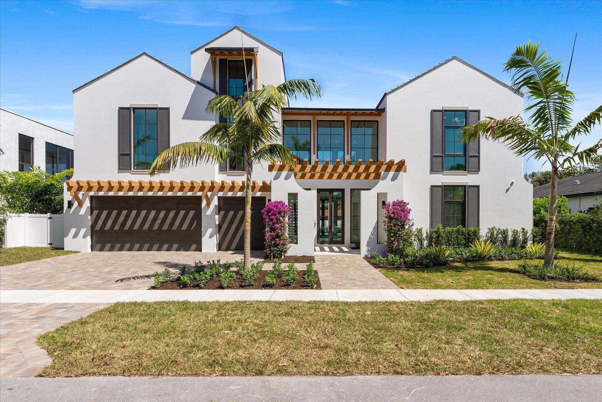880 Northeast 3rd Avenue Boca Raton, FL 33432 - Photo 4 of 100 a front view of a house with a yard