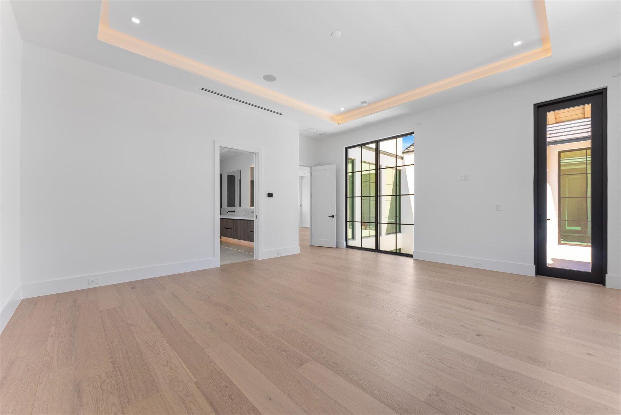 880 Northeast 3rd Avenue Boca Raton, FL 33432 - Photo 44 of 100 a view of an empty room with wooden floor and a window