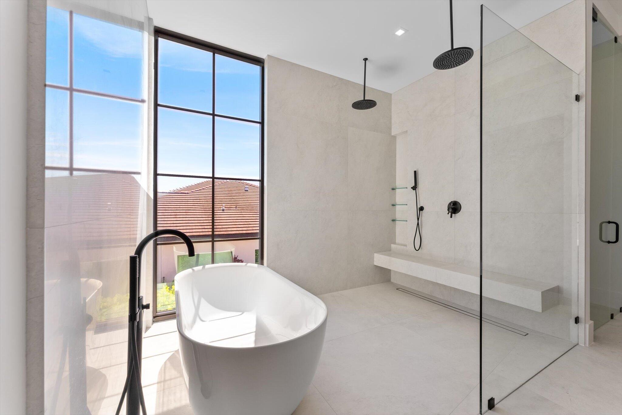 880 Northeast 3rd Avenue Boca Raton, FL 33432 - Photo 52 of 100 a bathroom with a bathtub and a shower