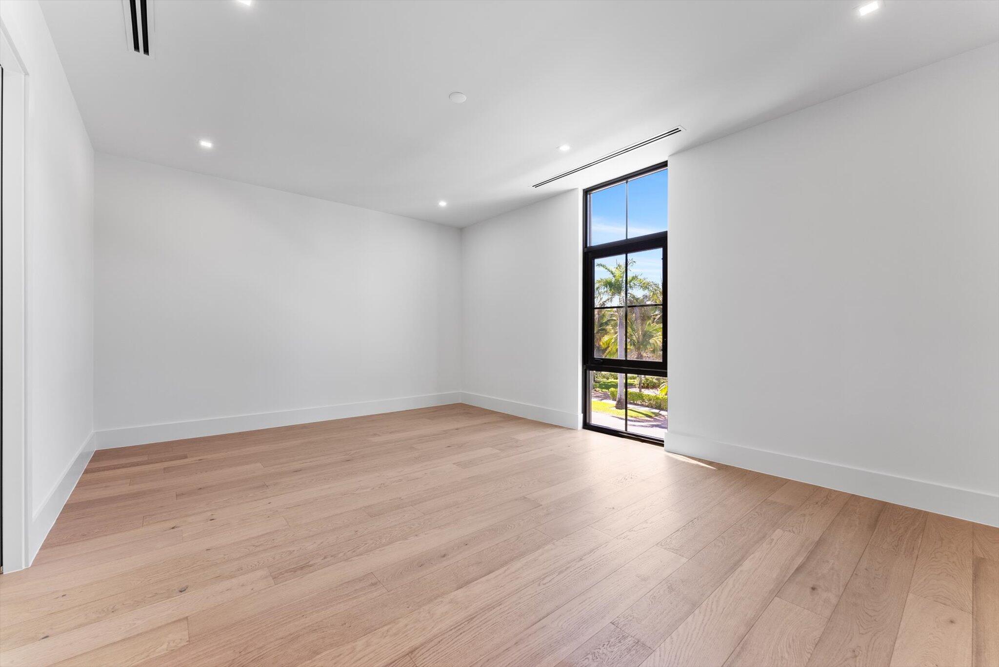 880 Northeast 3rd Avenue Boca Raton, FL 33432 - Photo 54 of 100 a view of an empty room with wooden floor and windows