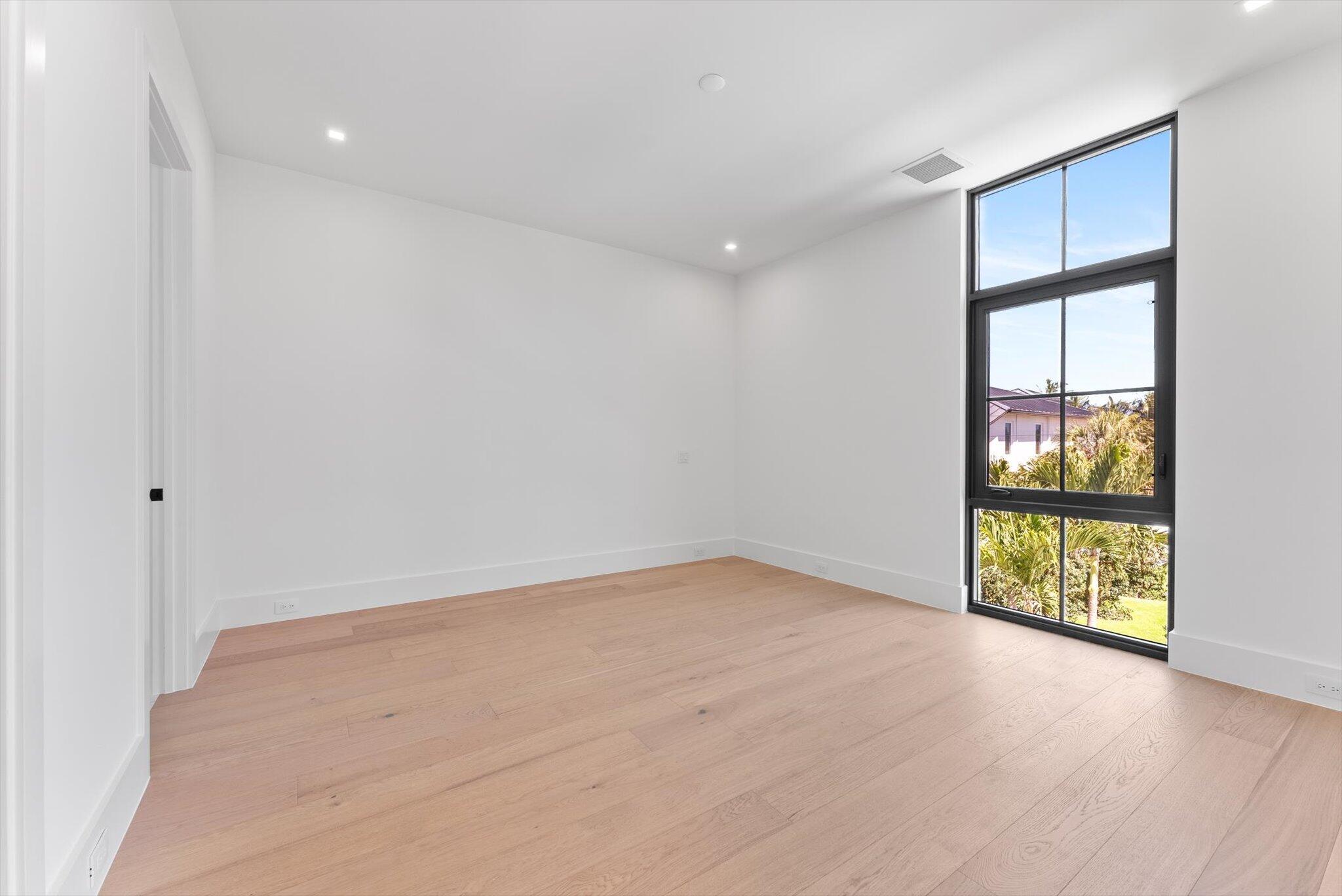 880 Northeast 3rd Avenue Boca Raton, FL 33432 - Photo 63 of 100 wooden floor in an empty room with a window