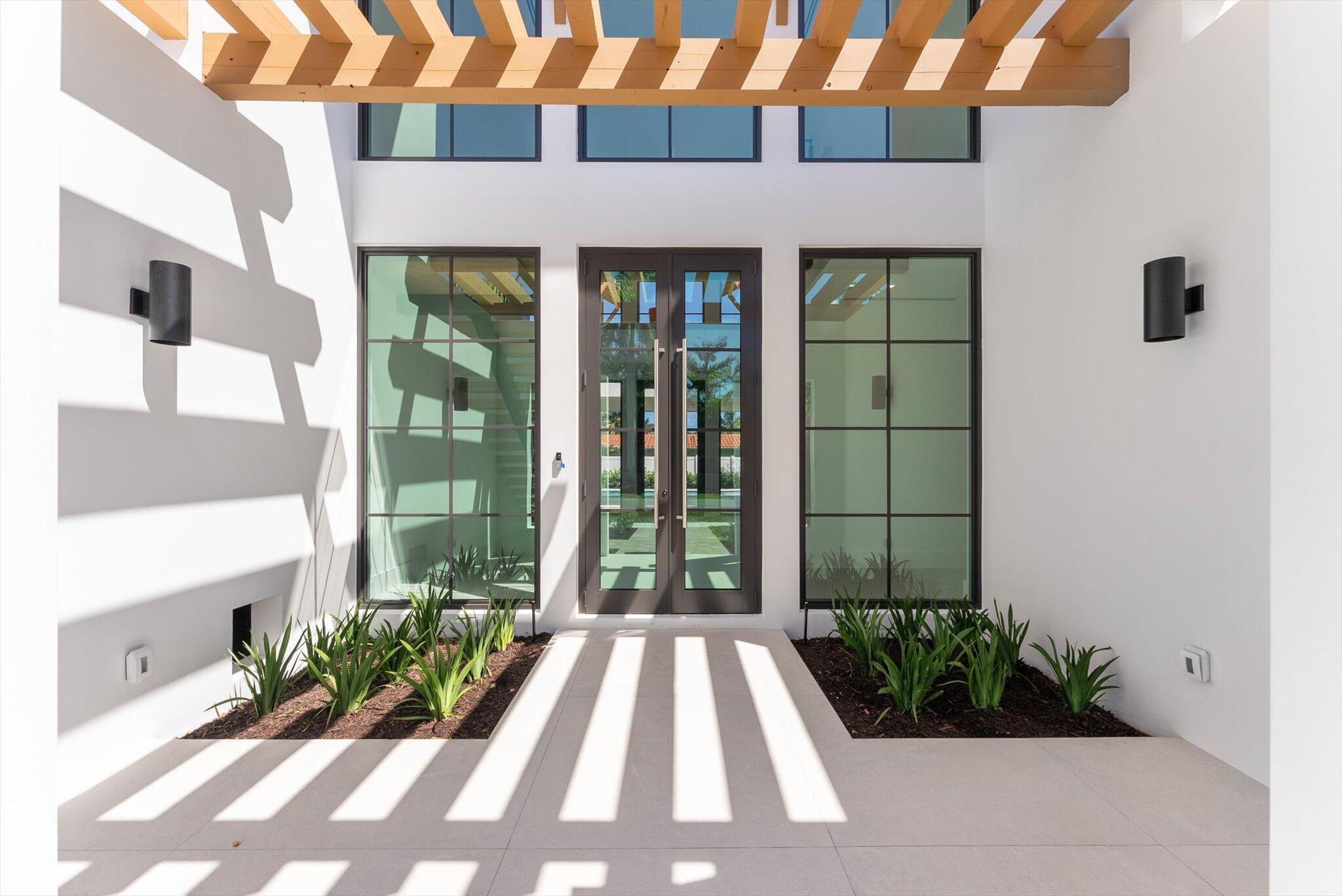 880 Northeast 3rd Avenue Boca Raton, FL 33432 - Photo 7 of 100 a front view of a house with garden