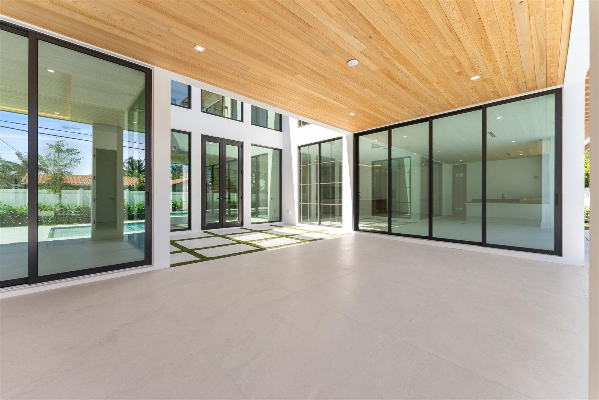 880 Northeast 3rd Avenue Boca Raton, FL 33432 - Photo 75 of 100 a view of an large building with a big yard