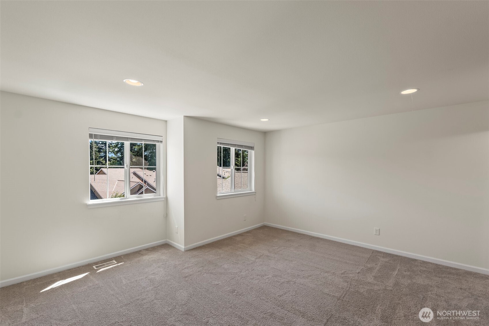 1080 East Old Ranch Road, Unit A1A2 Allyn, WA 98524 - Photo 27 of 35 an empty room with windows and closet