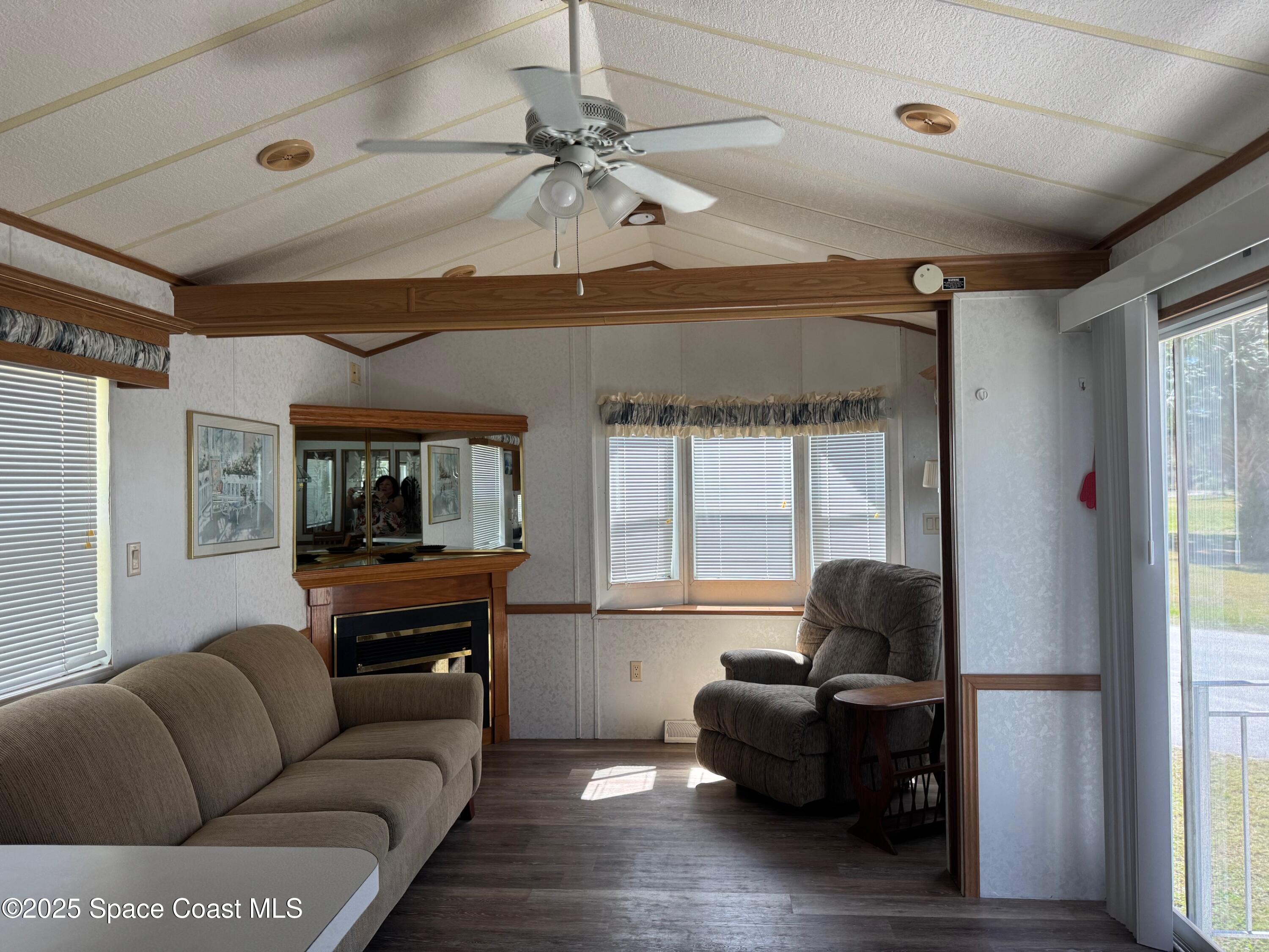 661 Snowbird Avenue, Unit 200 Cocoa, FL 32926 - Photo 2 of 7 a living room with furniture and a large window