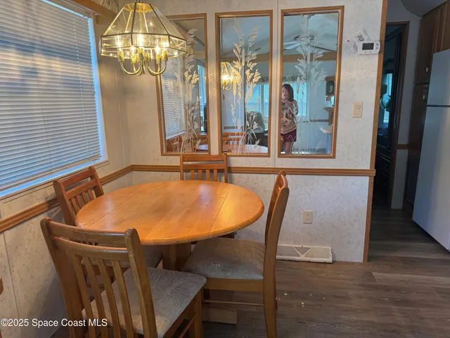 a view of a dining room with furniture and chandelier