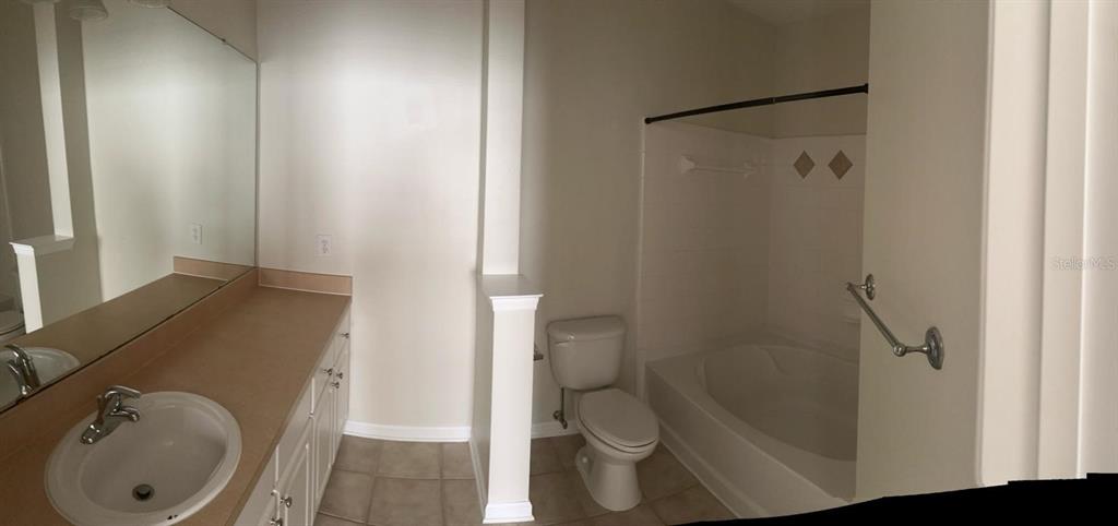 12861 Madison Pointe Circle, Unit 207 Orlando, FL 32821 - Photo 11 of 13 a bathroom with a sink and toilet