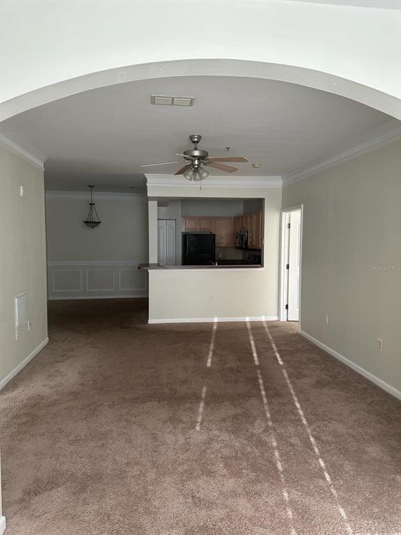 12861 Madison Pointe Circle, Unit 207 Orlando, FL 32821 - Photo 6 of 13 a view of an empty room with a fireplace and a window