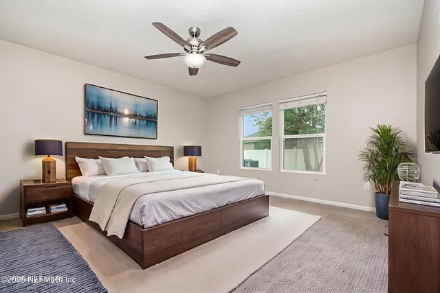 a spacious bedroom with a large bed and a window