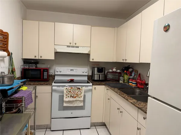 a kitchen with stainless steel appliances granite countertop a stove and cabinets