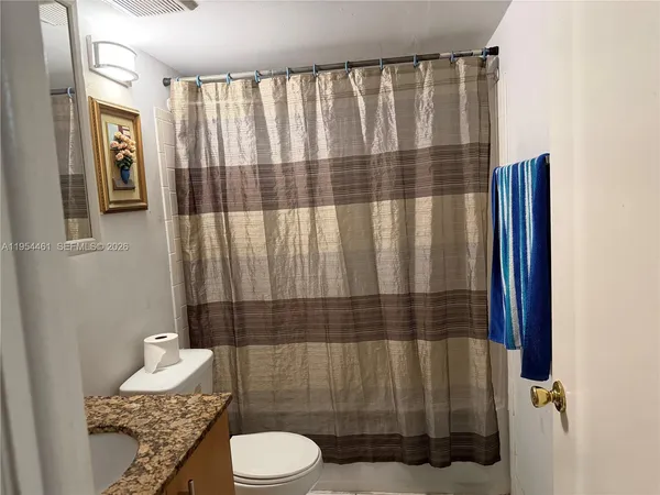 a bathroom with a toilet a sink and shower