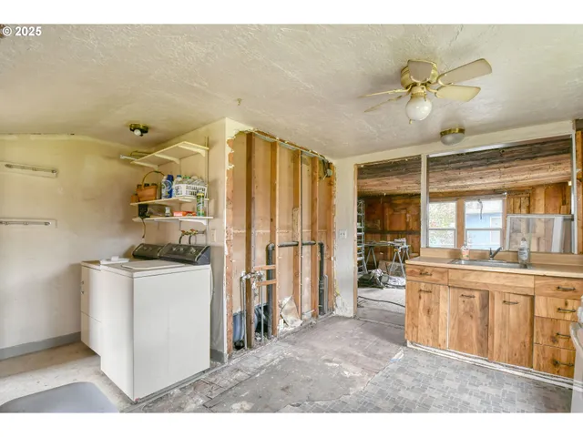a kitchen with stainless steel appliances kitchen island granite countertop a refrigerator and a stove top oven