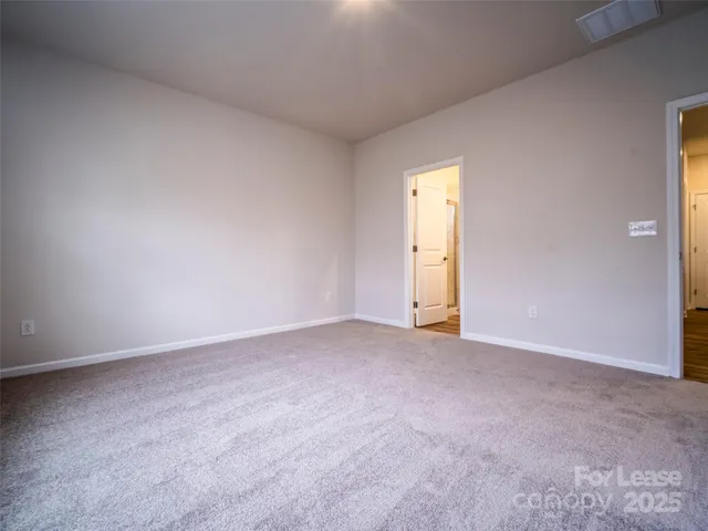 an empty room with a window and a mirror