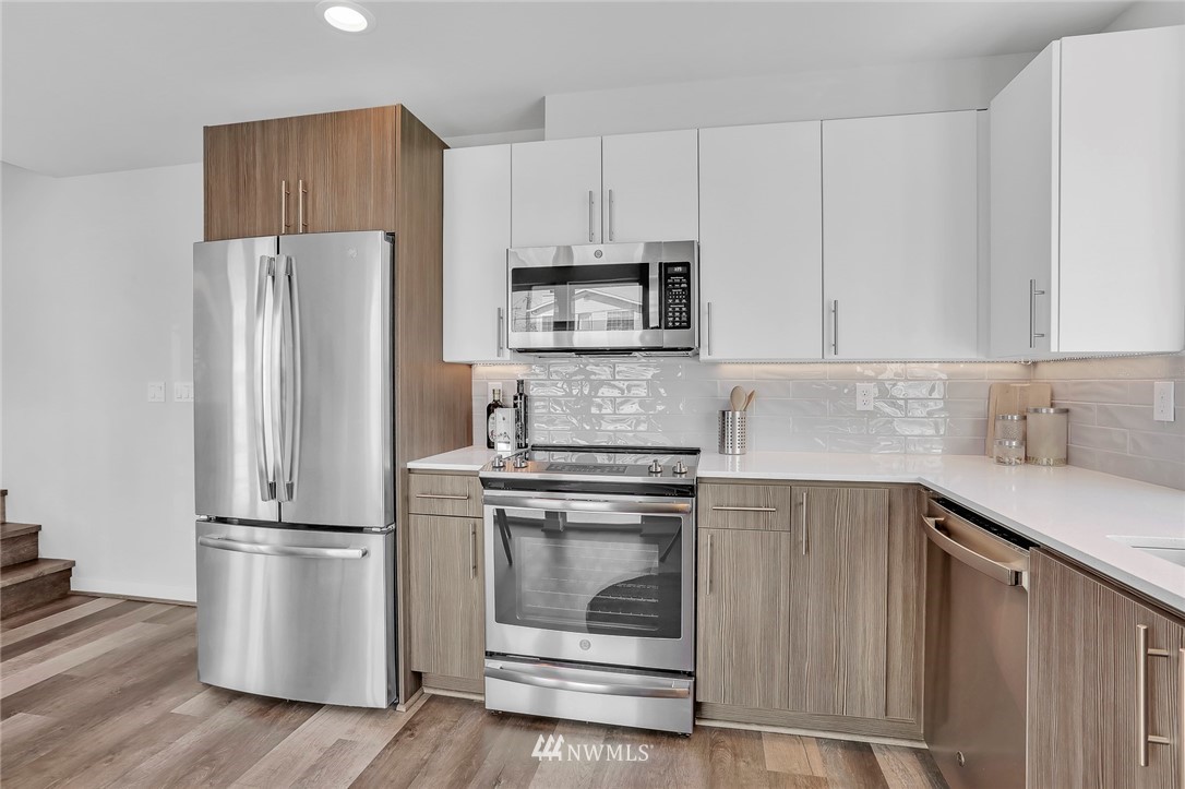 6249 8th Avenue Northwest Seattle, WA 98107 - Photo 13 of 31 a kitchen with wooden cabinets and stainless steel appliances