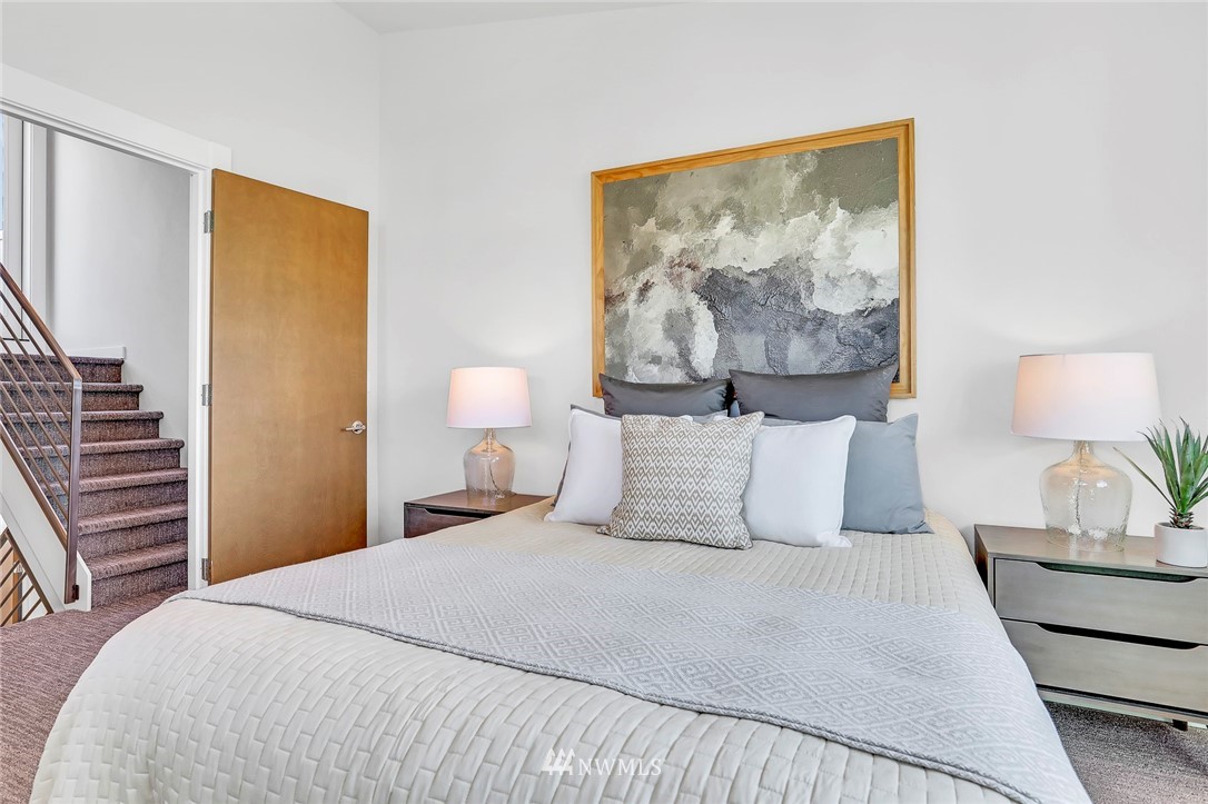 6249 8th Avenue Northwest Seattle, WA 98107 - Photo 15 of 31 a bedroom with a bed and a lamp on table