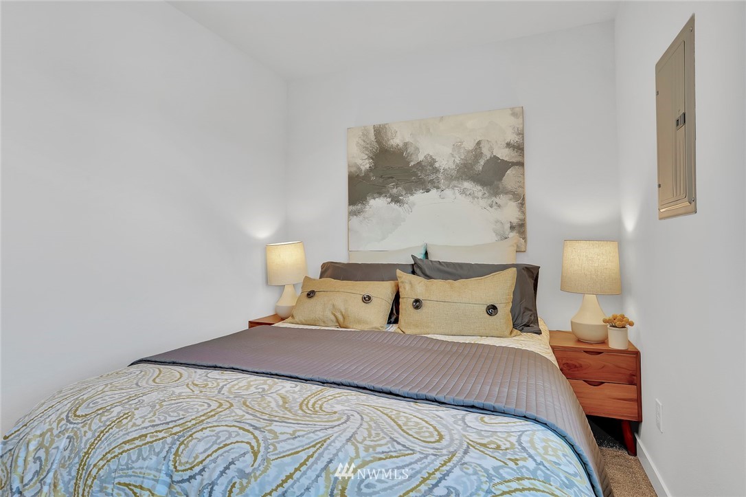 6249 8th Avenue Northwest Seattle, WA 98107 - Photo 20 of 31 a bedroom with a bed and painting on the wall