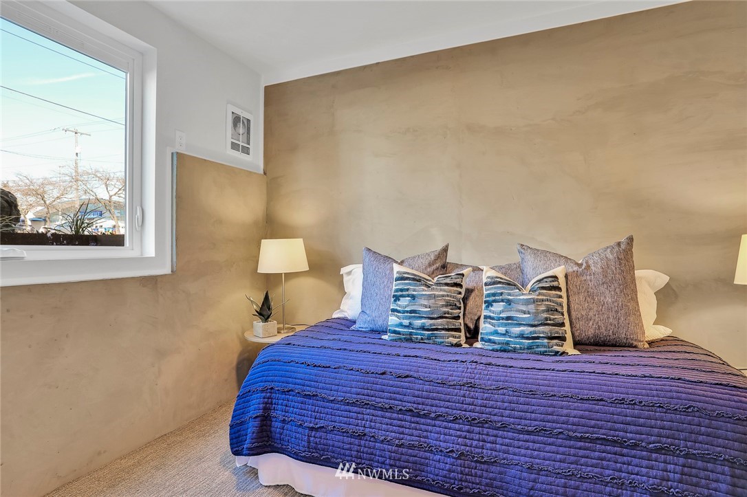 6249 8th Avenue Northwest Seattle, WA 98107 - Photo 23 of 31 a bedroom with a bed and a painting on the wall