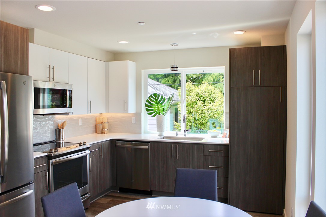 6249 8th Avenue Northwest Seattle, WA 98107 - Photo 10 of 31 a kitchen with a refrigerator and a sink