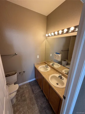 a bathroom with a sink toilet and mirror